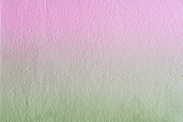 La struttura di un muro di gesso tinto in sfumature di rosa e verde