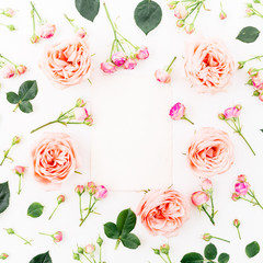 Floral background. Round frame with pink roses, petals, leaves isolated on white background. Flat lay, top view.
