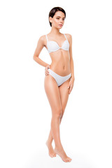 Fototapeta premium A full portrait of young pretty girl with hand on her wasit posing on white background