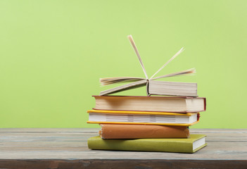 Open book, hardback books on wooden table. Education background. Back to school. Copy space for text.