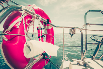 Life buoy with ropes and toilet paper on boat