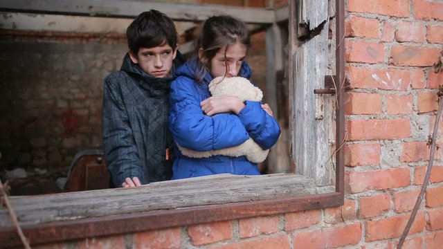 Children refugees against the backdrop of bombed houses. war
