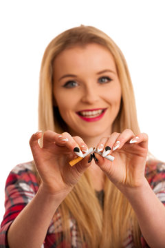 Young woman breaks cigarette as gesture for quit smoking isolated over white