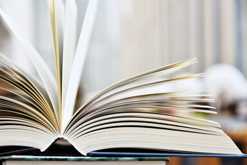 Fototapeta premium Hardcover book lying on the table in the library