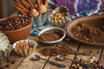 Roasted black and green coffee beans and ground coffee in the plate