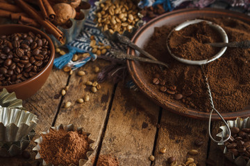 Roasted black and green coffee beans and ground coffee in the plate