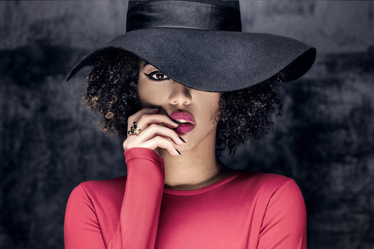 Portrait of african american girl in hat.