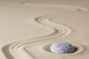Zen background with stone and line in the sand. Focus on concentration and spirituality for harmony and purity...