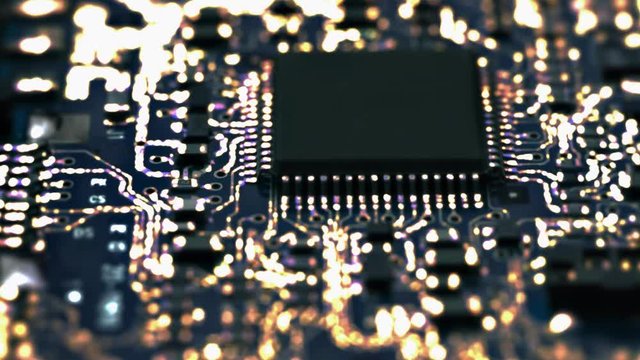 Circuit Board / Processor Chips / Data Streams. Macro tracking over circuit board with conceptual image of the yellow-orange electrical signals flowing in electrical conductors.