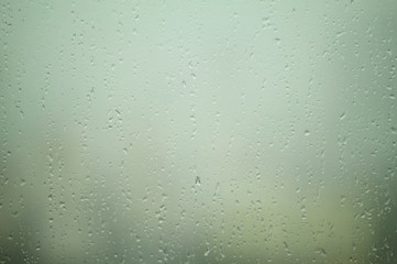 Raindrops falling on a glass for Background