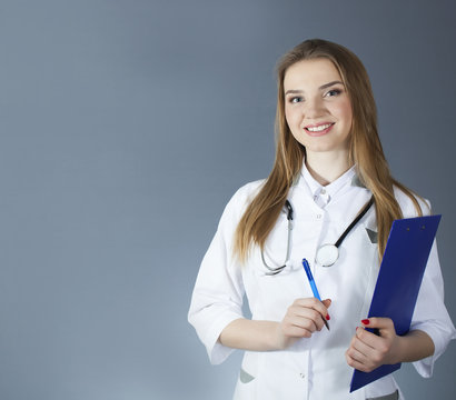Attractive woman doctor, nurse holding  paper tablet ,place for text