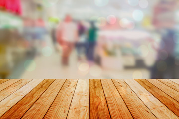 blurred image wood table and abstract department store shopping mall center and people background