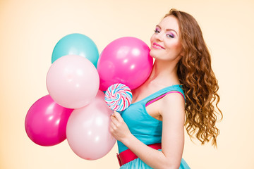 Woman with colorful balloons and lollipop