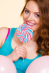 Woman with colorful balloons and lollipop