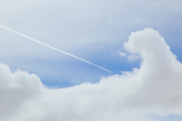 Airplane Streaking Through the Clouded Sky
