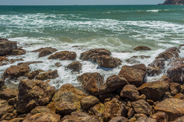 Fototapeta na wymiar Close up view of seascape with hard rocks and still waves, Kailashgiri, Visakhapatnam, Andhra Pradesh, March 05 2017