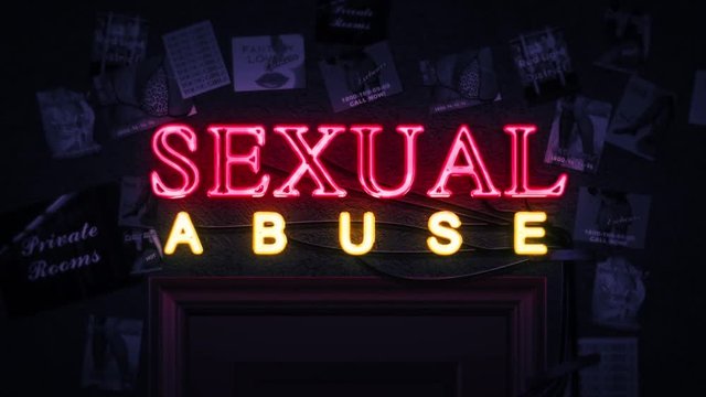 Sexual Abuse Neon Sign Turning on and Off Above a Door