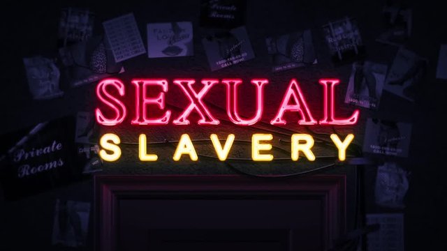 Sexual Slavery Neon Sign Turning on and Off Above a Door