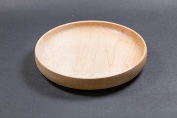 Empty wooden plate in black background.