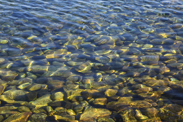 Stones under transparent water, background