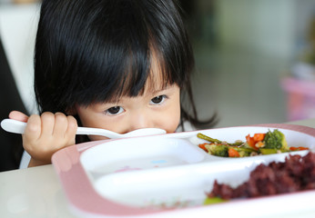 Close-up asian girl age about 2 years old eating