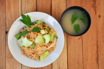 Instant noodles fried with egg Pork and vegetables with soup. copy space.