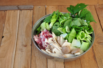 pork, vegetables, mushrooms, eggs, celery, arranged in a metal bowl. Copy space. Object. Slicing.