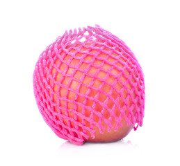 Pink foam net with apple on white background