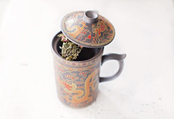 Chinese cup with a spoon of tea