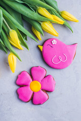 Spring background card cookies and flowers yellow tulips. Easter or Mother day holidays content