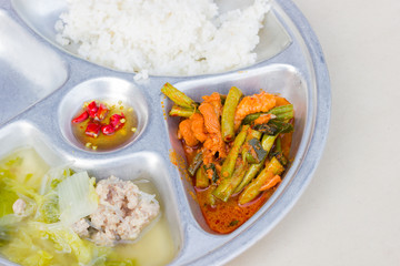 closeup stainless tray with Thai food, shallow depth of field.