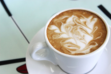Cappuccino on tablecloth