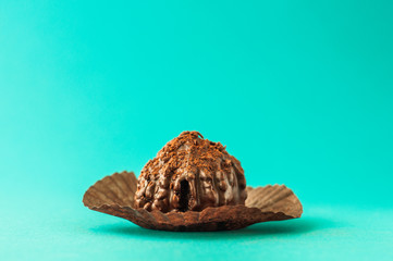 Chocolate chip muffin in brown wax paper. Unwrapped