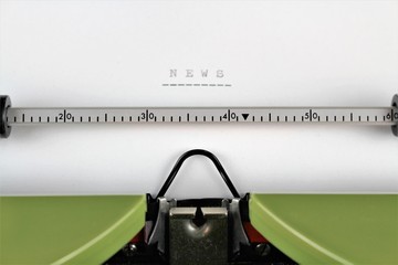 An image of a typewriter with a news