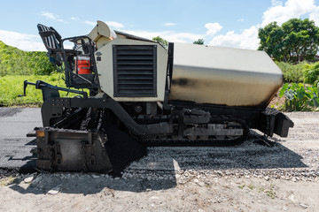Fototapeta na wymiar Asphalt road paver paiving machine construction industry roadwork repair