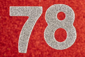 Number seventy-eight silver color over a red background. Anniversary.