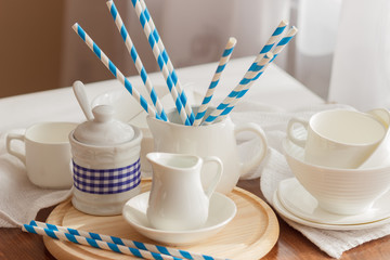 Set of white empty tableware with striped tubules