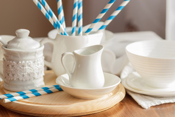 Set of white empty tableware with striped tubules