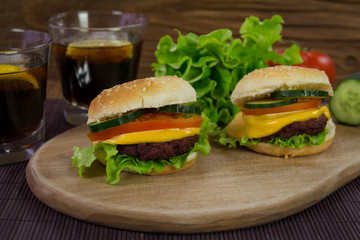 Cheeseburgers on wooden plank