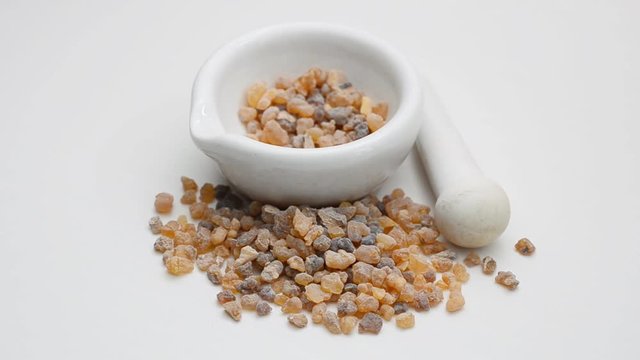 Frankincense olibanum resin with pharmaceutical mortat and pestle. Rotate.