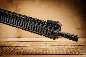 black assault rifle on an old wooden table