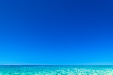 Fototapeta na wymiar Blue sea, blue sky and Paradise Tropical beach / Vacation holidays background wallpaper..