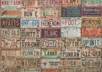 Vintage collage of old American car plates.