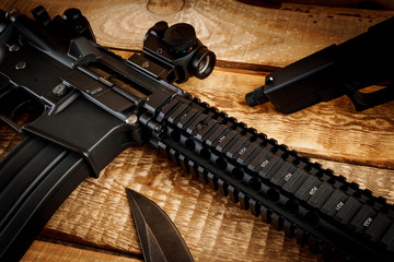 black assault rifle on an old wooden table