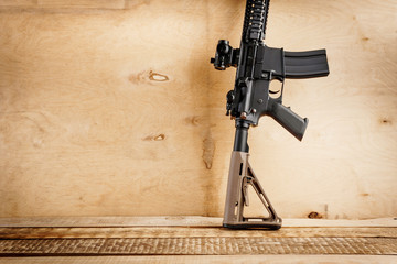 black assault rifle on an old wooden table