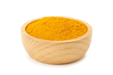 turmeric powder in wooden bowl