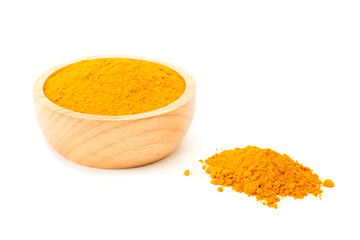 turmeric powder in wooden bowl