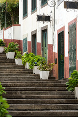 Fototapeta na wymiar Steep stairs decorated with flowers in Sao Vincente. Madeira. Portugal