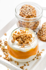 dessert with pumpkin, cream and biscuits, vertical top view