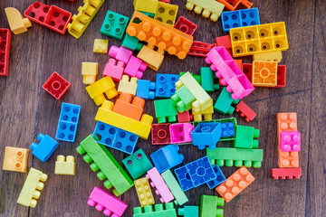 Plastic toy blocks on wood backdround